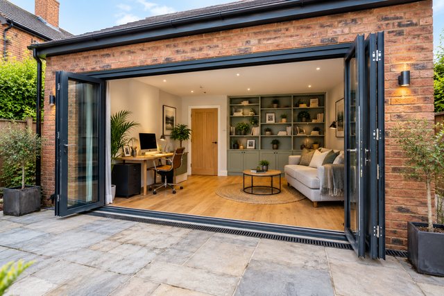 Example image: a converted garage finished as a living space with glazed doors