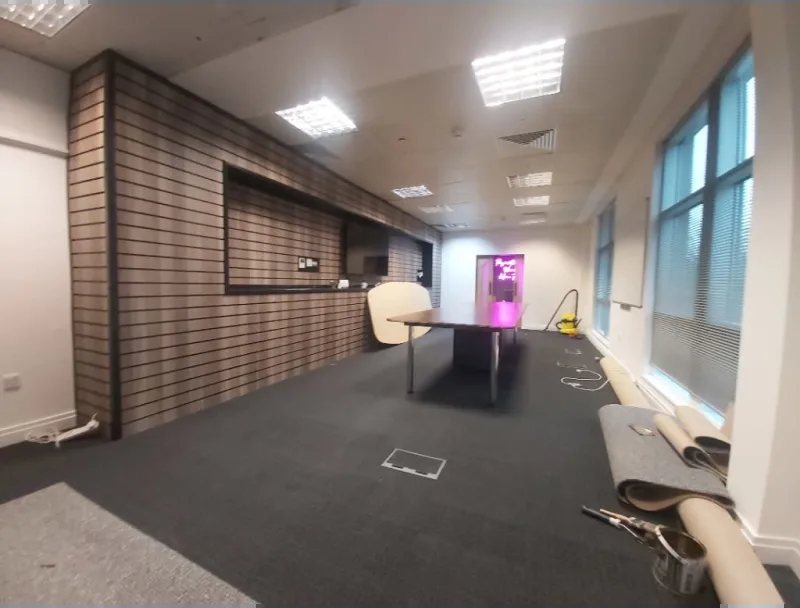 A commercial unit being fitted out, with the slatted feature wall up and the floor going down