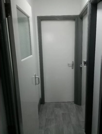 A hallway finished with a new door, frame and flooring