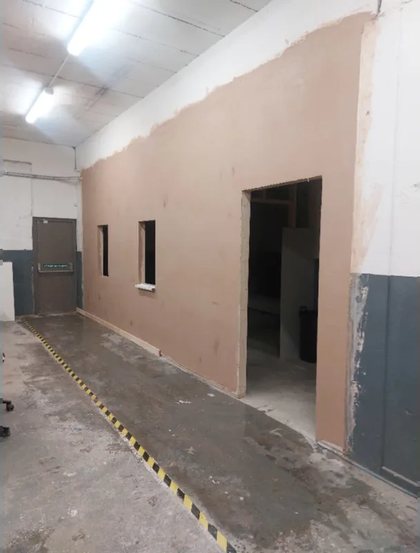 A commercial unit stripped back, with the walls being made good