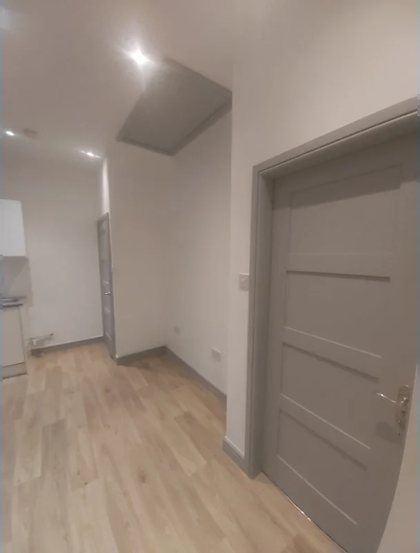 A room replastered and decorated, with new flooring and spotlights