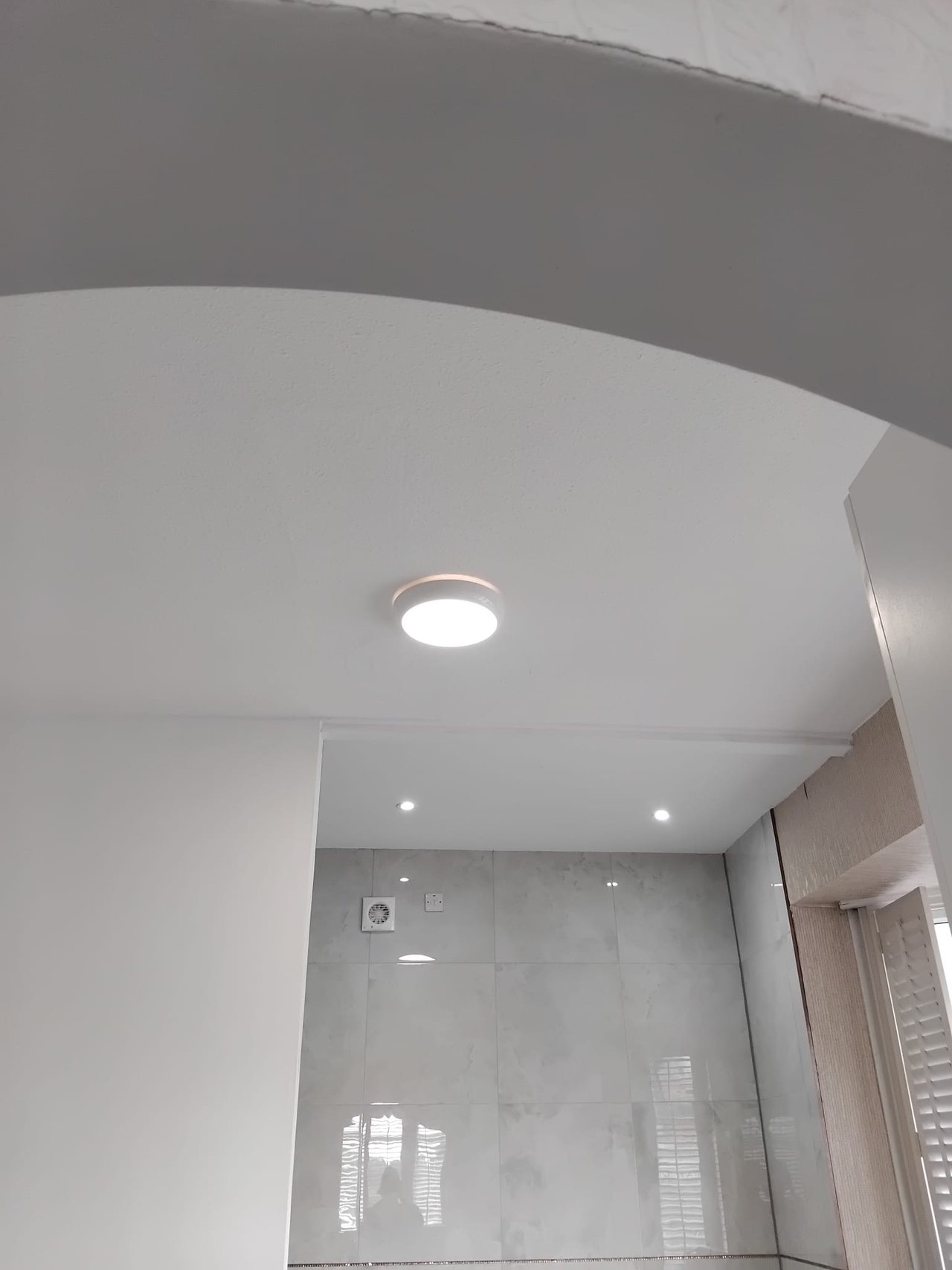 The finished arch with its ceiling light, looking through into the tiled bathroom