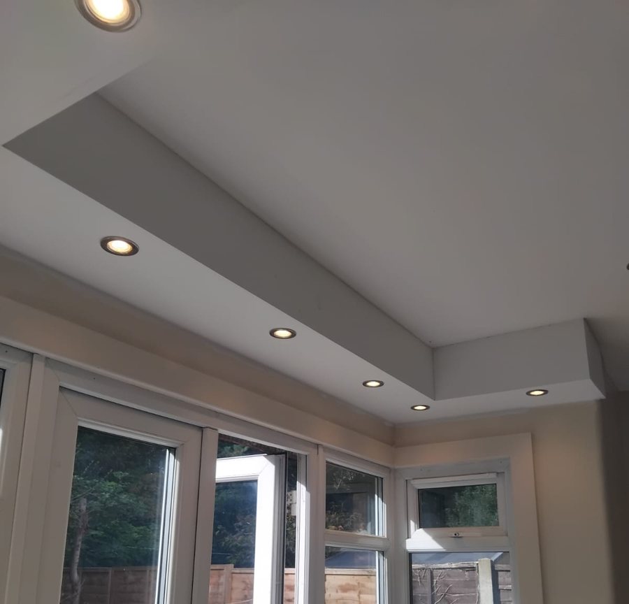A new dropped ceiling bulkhead with downlights over the bay and the garden doors